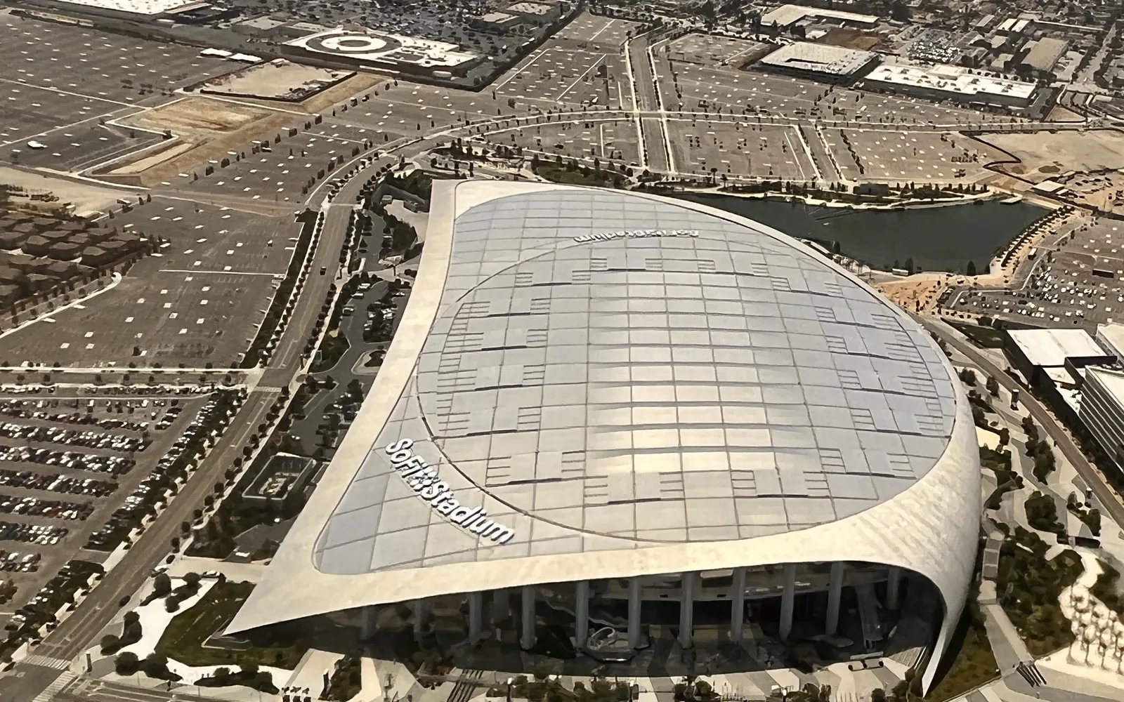 Aerial view of SoFi Stadium in Inglewood, showing the modern sports venue with its distinctive translucent roof